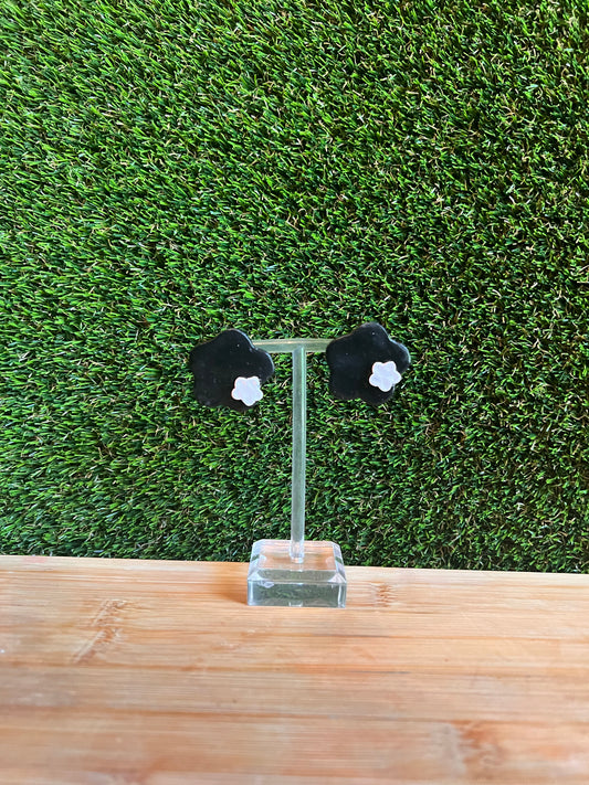 Black flower with small hand carved white flower